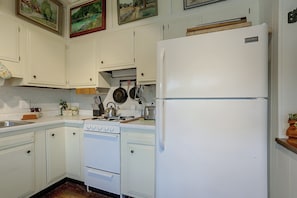A kitchen with white cabinets, a white refrigerator, a stove, and a sink. - Rustic Cabin-Stunning View-Cov Porch<br>Delaware Gem! (Damascus)