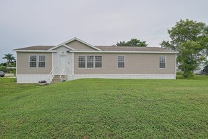 A single-story mobile home with a front porch and a small set of stairs leading to the entrance. - Extended Retreat, Spacious Home in Naples (Naples)