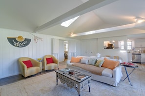 A spacious living room with a sofa, armchairs, a coffee table, and a decorative fan. - Steps to Cove Park Boat Ramp! Kemah Home w/ Yard (Kemah)
