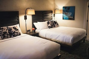 A hotel room with two beds, each with a headboard and bedside lamps. - Hi-ho: A Hi-tech Hotel (Fairfield)