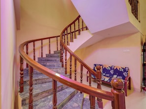 A wooden staircase with a handrail leading to a landing. - Hotel O Vsv Guest House Maduravoyal (Chennai)