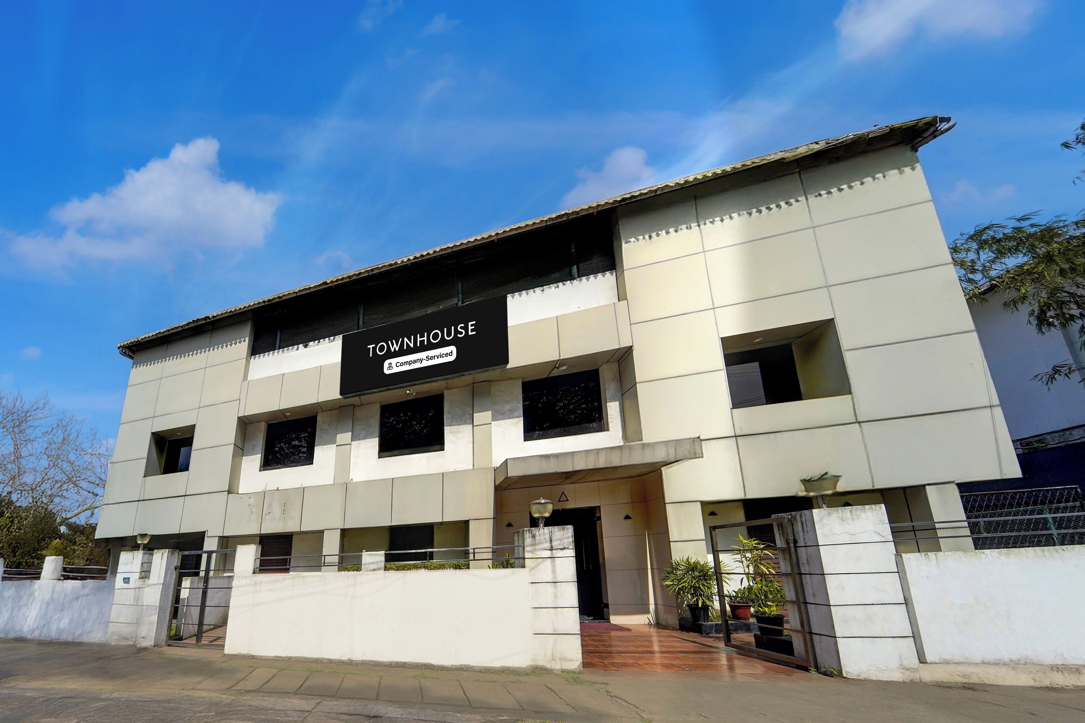 A modern building with a sign indicating it is a serviced company property.