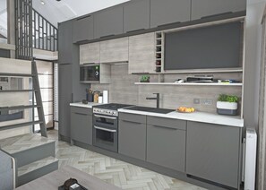 A modern kitchen with grey cabinetry, a built-in stove, a microwave, and a sink. There is a wooden staircase leading to an upper level. - Autograph S Pod Escape 6 (Hot tub) (Thirsk)