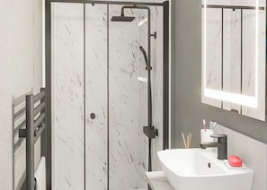 A modern bathroom with a white sink, a mirror, and a shower enclosure. - Autograph S Pod Escape 4 Pet Friendly (Hot tub) (Thirsk)