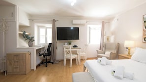 A hotel room with a bed, desk, chair, TV, and a small cabinet. - Alto Studio by CorfuEscapes (Kerkira)