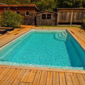 A rectangular swimming pool with a wooden deck surrounding it. - New Listing (Lège-Cap-Ferret)