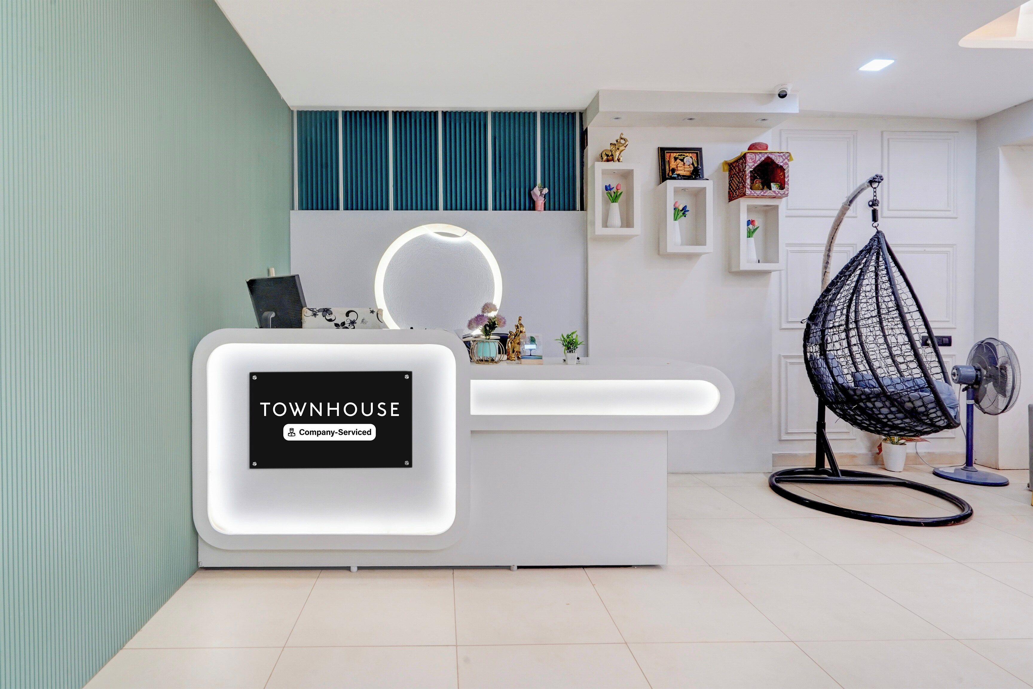 A reception desk with a sign reading 'TOWNHOUSE Company-Serviced.'
