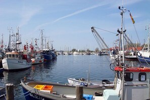 A marina with multiple boats docked, including a boat with 'BUR 20' and another with 'BUR 105' visible. - Holiday apartment with 2 bedrooms (Burg auf Fehmarn)