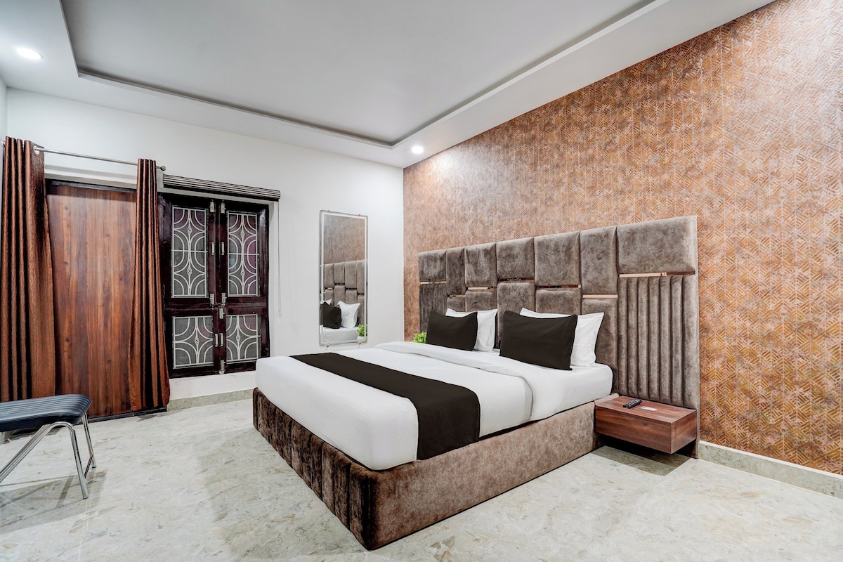 Un dormitorio moderno con una cama grande, un armario de madera y una pared con diseño.