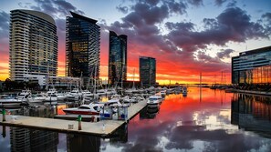 A marina with boats docked, surrounded by modern high-rise buildings. - Docklands Rooftop Pool Retreat (Docklands)