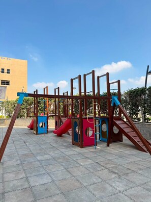 A playground with slides and climbing structures. - Your Dream Studio in New Cairo E104, AC, Wi-Fi, Prime Location (Cairo Governorate)