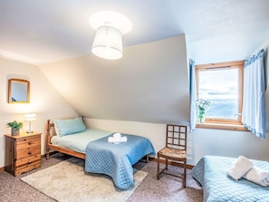 A bedroom with a bed, a chair, a dresser, a window with a view, and a ceiling light. - Wonderful private villa for 5 guests with WIFI, TV, pets allowed and panoramic view (Boleskine)