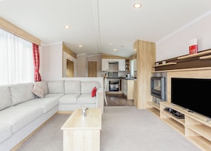 A modern living room with a sofa, a coffee table, and a television. - 1 bedroom accommodation in Fort Augustus (Fort Augustus)