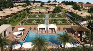 Un complex turístic amb diverses allotjaments tipo bungalow, una piscina central i jardins ben cuidats.