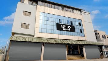 A hotel building with a sign that reads 'HOTEL' and 'Company Serviced'.