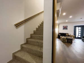 A staircase leading to a living area with a sofa and a coffee table. - House Sleeps 4 With Parking and Balcony (Tarouca)