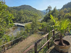 A river with a bridge, surrounded by lush greenery and hills. - New Listing (Piemonte)