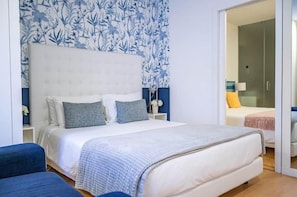 A bedroom with a bed, bedside tables, and a wardrobe.