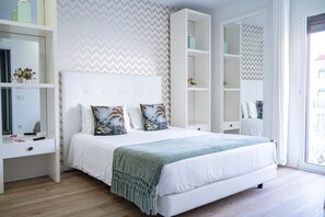 A modern bedroom with a large bed, built-in wardrobe, and a mirror. - Superior Double Suite with Balcony and Sea View (Nazaré)