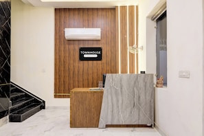 A reception desk with a sign that reads 'TOWNHOUSE Company Serviced.'
