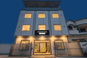 A modern building with a sign reading 'TOWNHOUSE Company Serviced.'