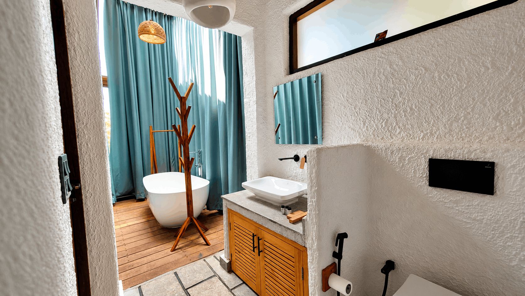 A bathroom with a bathtub, a sink, wooden cabinets, and a towel rack.