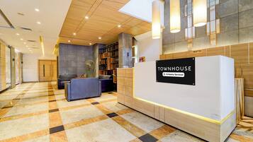 A reception area with a check-in counter, seating, and a reception desk.