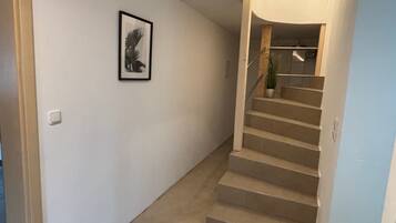 Una escalera con barandilla que lleva a un rellano.