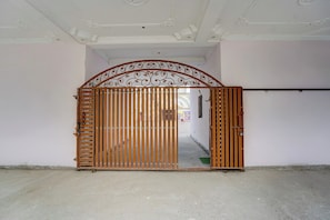 A gated entrance with a decorative metal arch and vertical bars. - Super Collection O Patna Airport (Danapur)
