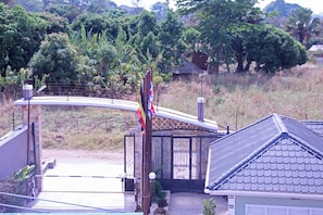 A residential area with a house, a gate, and a flagpole.