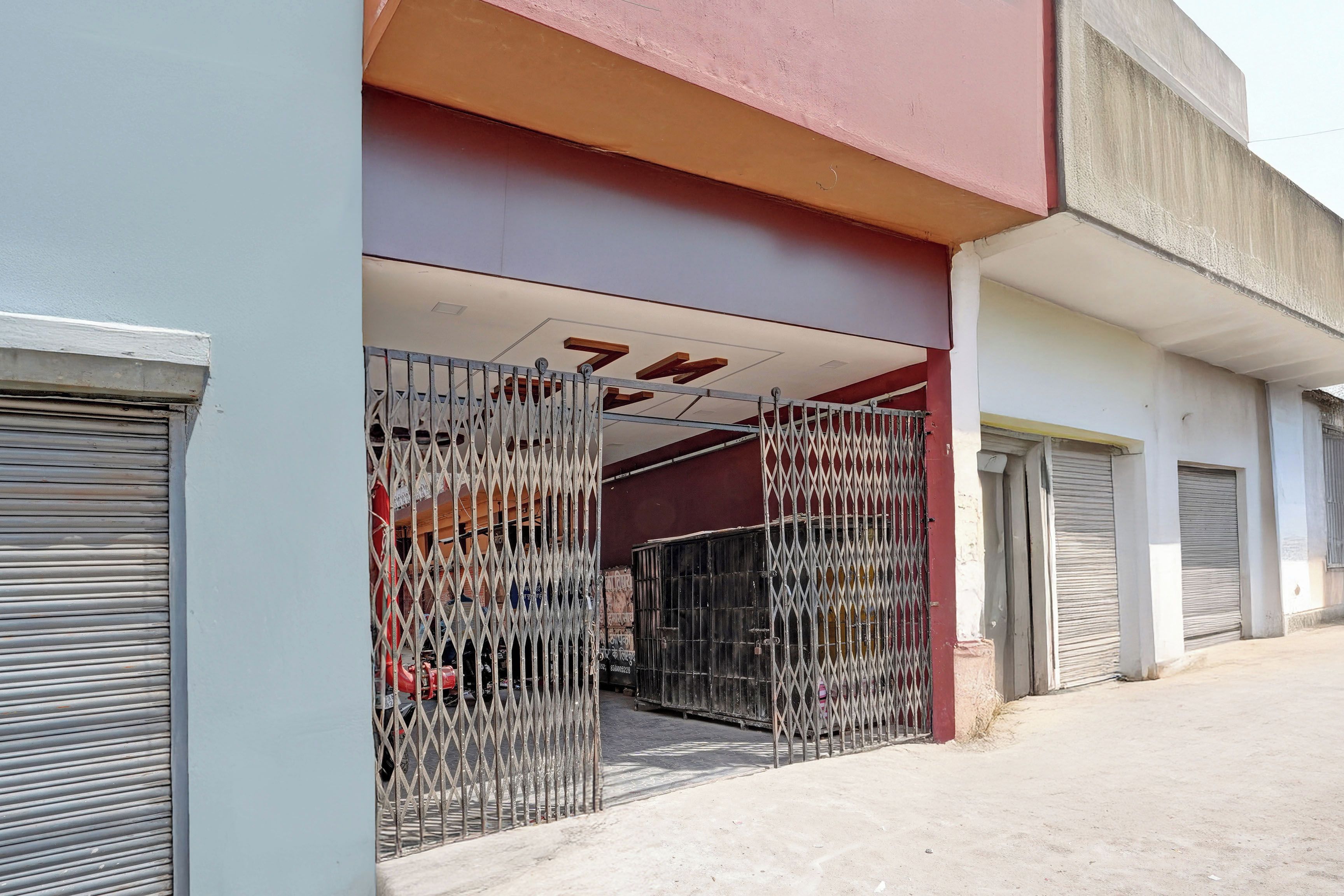 A building entrance with metal gates and a closed shutter.