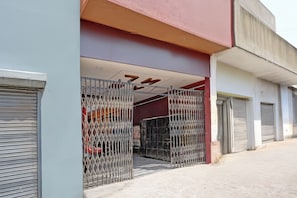 A building entrance with metal gates and a closed shutter.
