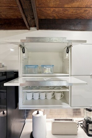 A kitchen with a built-in refrigerator, a toaster, and a blender on the counter. - Wooded golf Course Retreat (Westerville)