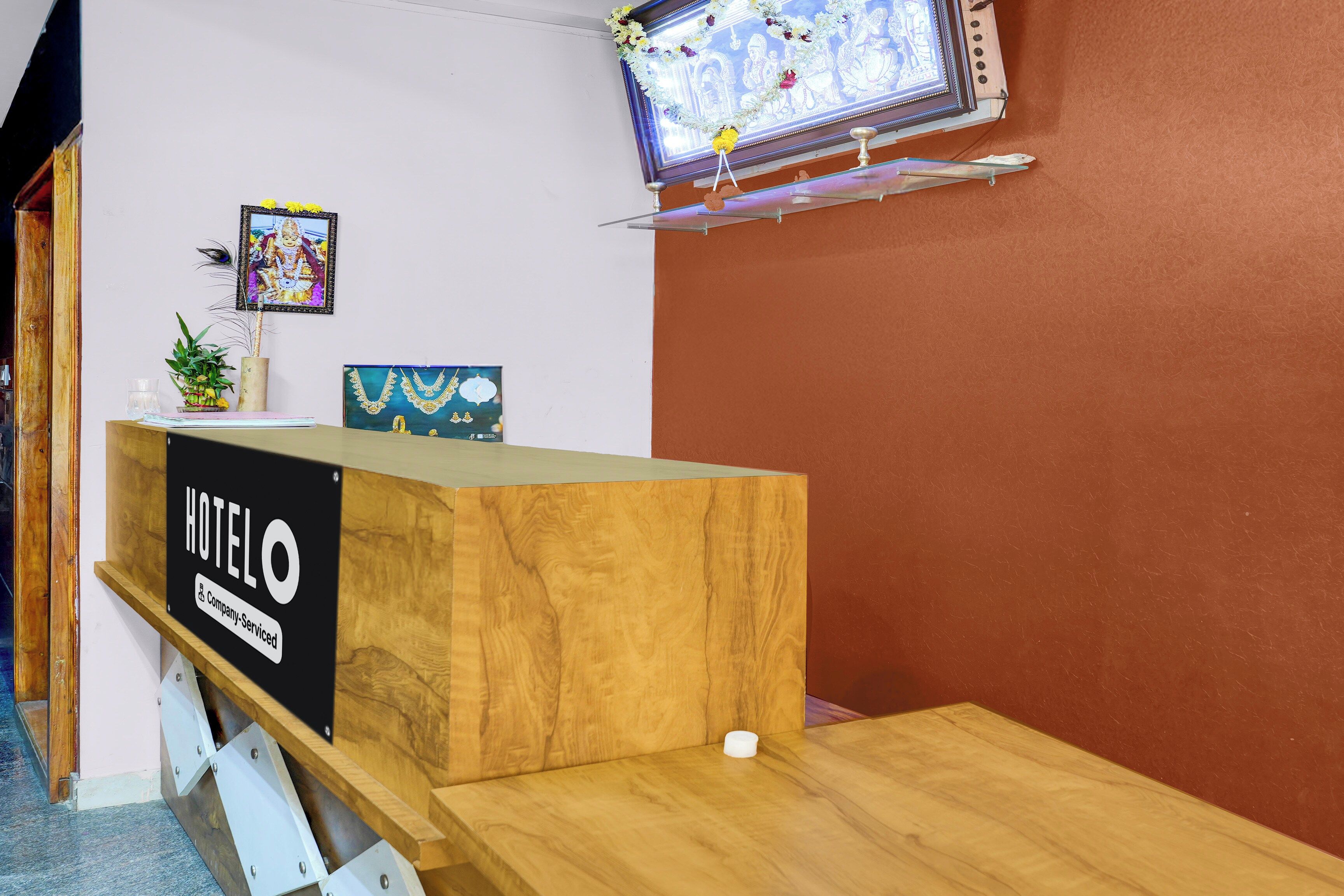 A hotel reception desk with a sign that reads 'HOTEL COMPANY-SERVED.'