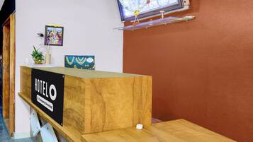 A hotel reception desk with a sign that reads 'HOTEL COMPANY-SERVED.'