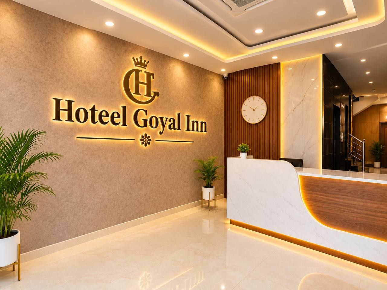 A reception area with a marble counter, a clock, and a wall-mounted sign for Hotel Goyal Inn.