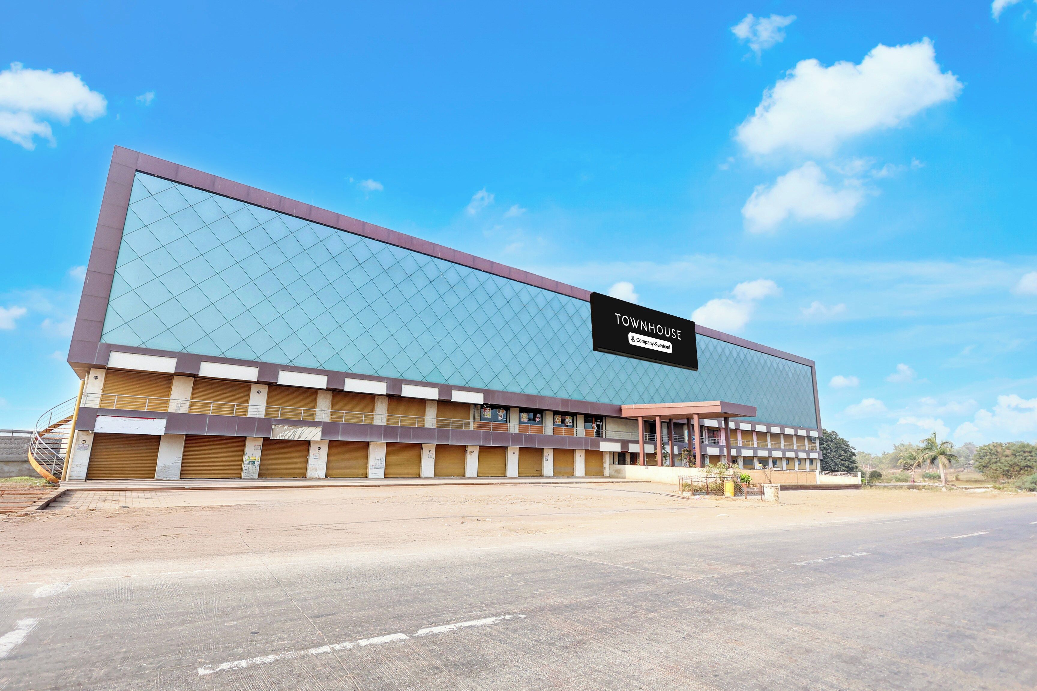 A large building with a sign reading 'TOWNHOUSE' and 'Company: Senior Viced'.
