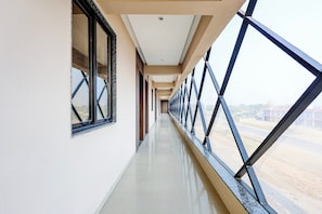 A corridor with large windows and a view of a construction site.