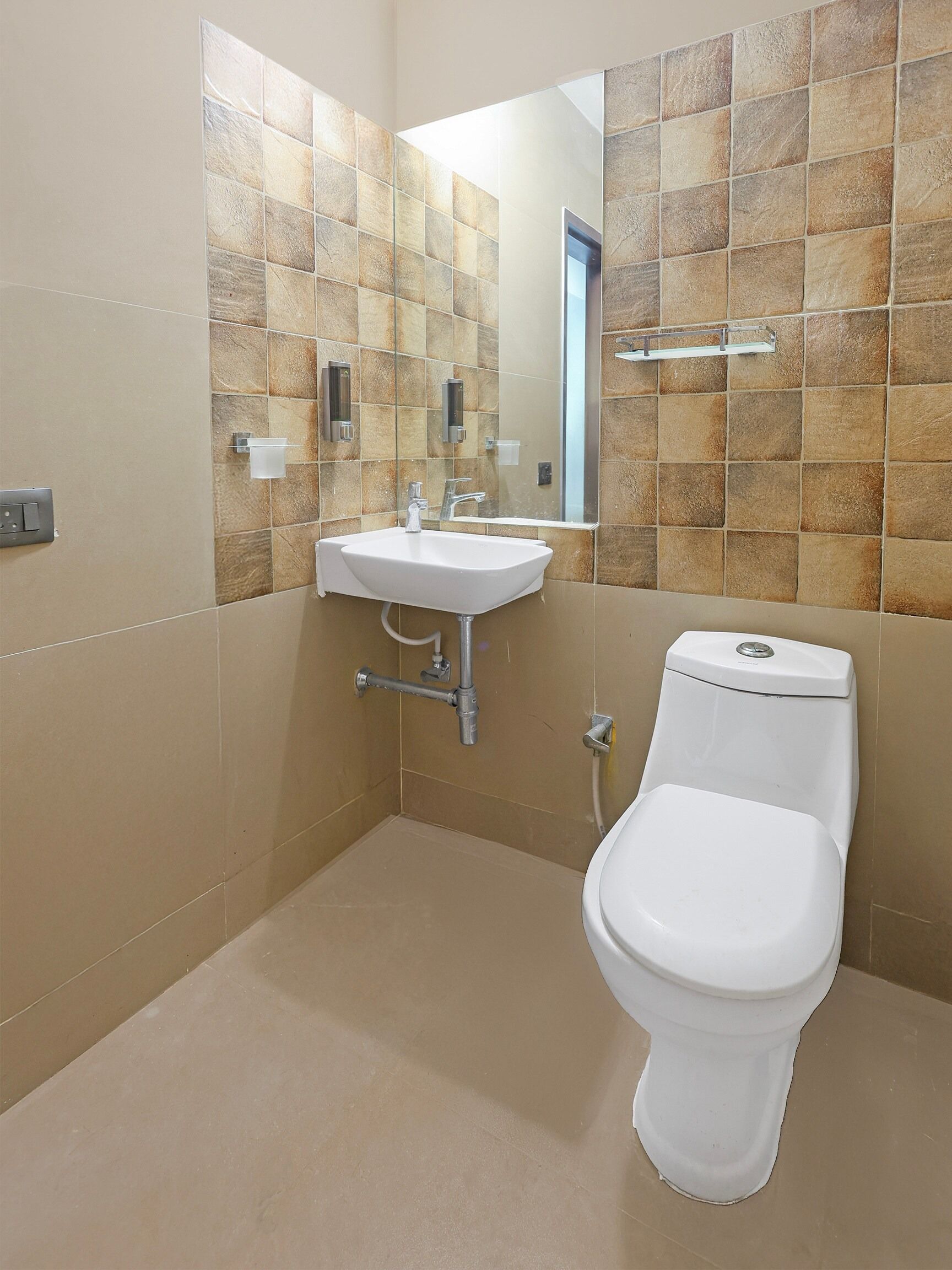 A bathroom with a white sink, a toilet, and a mirror.
