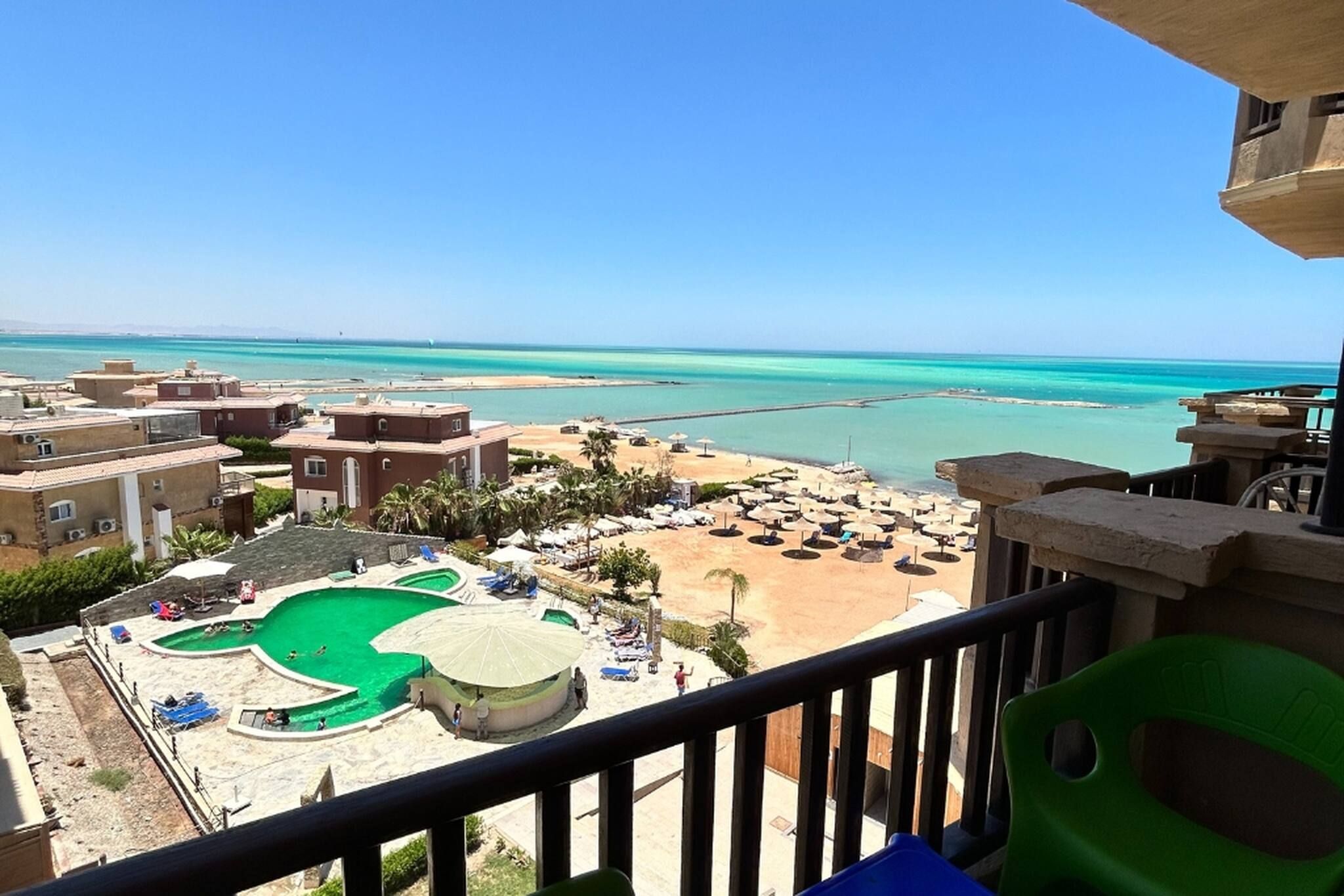 A resort with a pool, beach, and ocean view.