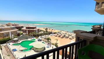 A resort with a pool, beach, and ocean view.