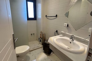 A bathroom with a toilet, sink, and a window. - 1BR Chalet With Pool, Front Sea View & Balcony (Hurghada)