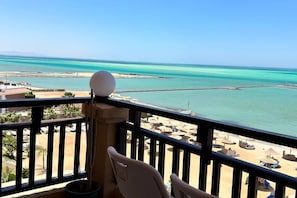 A balcony with a view of a beach and the sea. - 1BR Chalet With Pool, Front Sea View & Balcony (Hurghada)