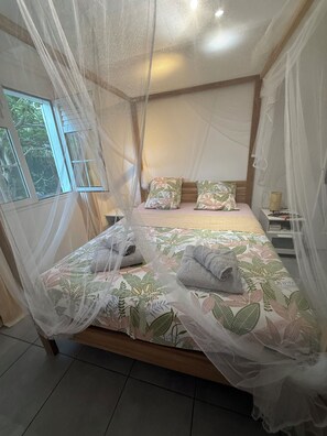 A bed with a canopy, pillows, and towels. - New Listing (Saint-François)