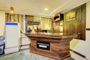 Een receptiebalie met een bord waarop 'Townhouse Company-Serviced' staat.