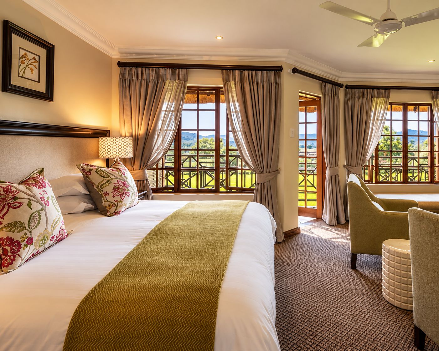 A hotel room with a bed, a chair, a lamp, and a view of the outdoors.