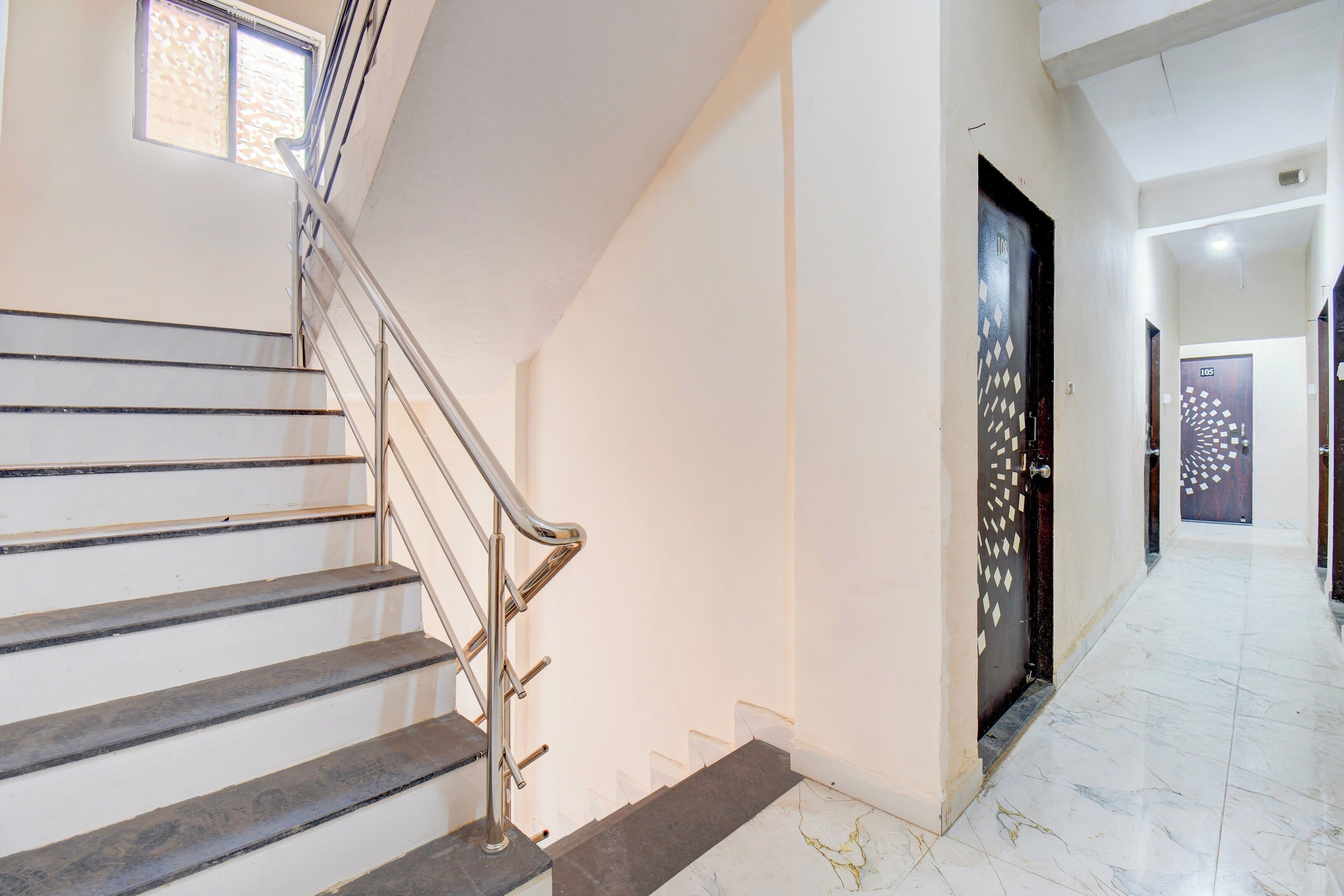 A staircase with metal railings leading to a landing.