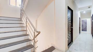 A staircase with metal railings leading to a landing.