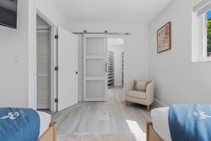 Una camera da letto moderna con un letto, una sedia e un armadio.