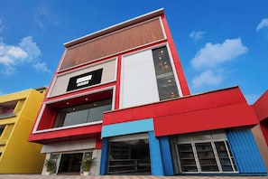 A modern building with a prominent sign for 'PALETTE' and 'OYO-Serviced' accommodations.